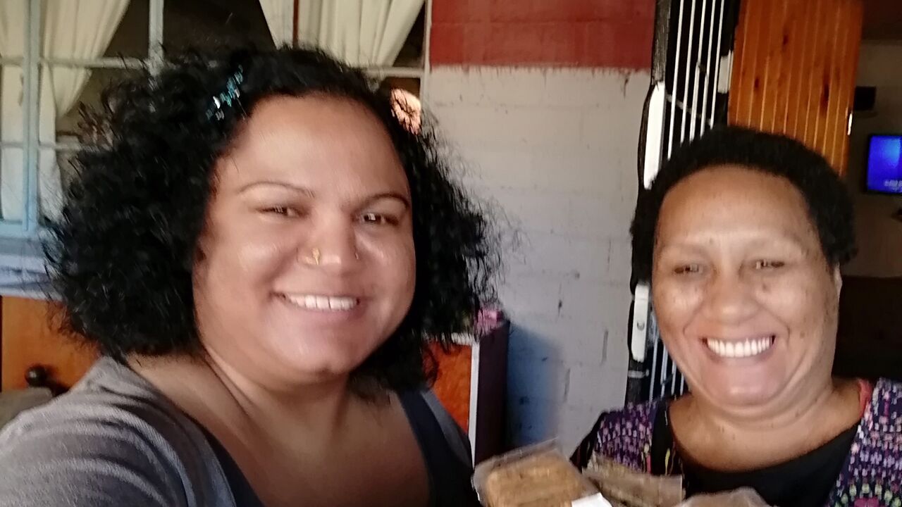 Kim Pillay delivering health biscuits to famous Ellen Pakkies who is also a community worker feeding her community